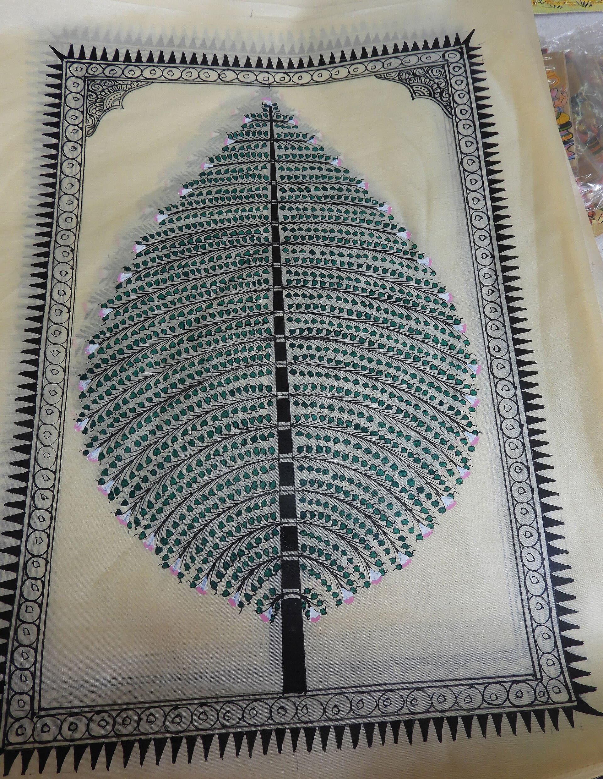 A contemporary Saura painting from Odisha featuring a tree motif and detailed geometric border